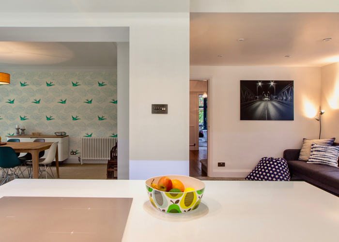 Modern open plan space looking into dining area and seating space