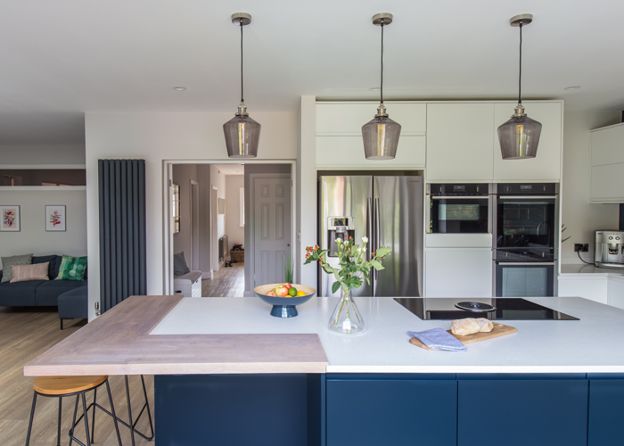 Deep blue and white kitchen, with large island and american fridge freezer
