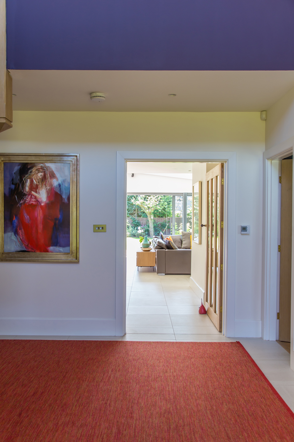 Hallway with artwork and bold colours