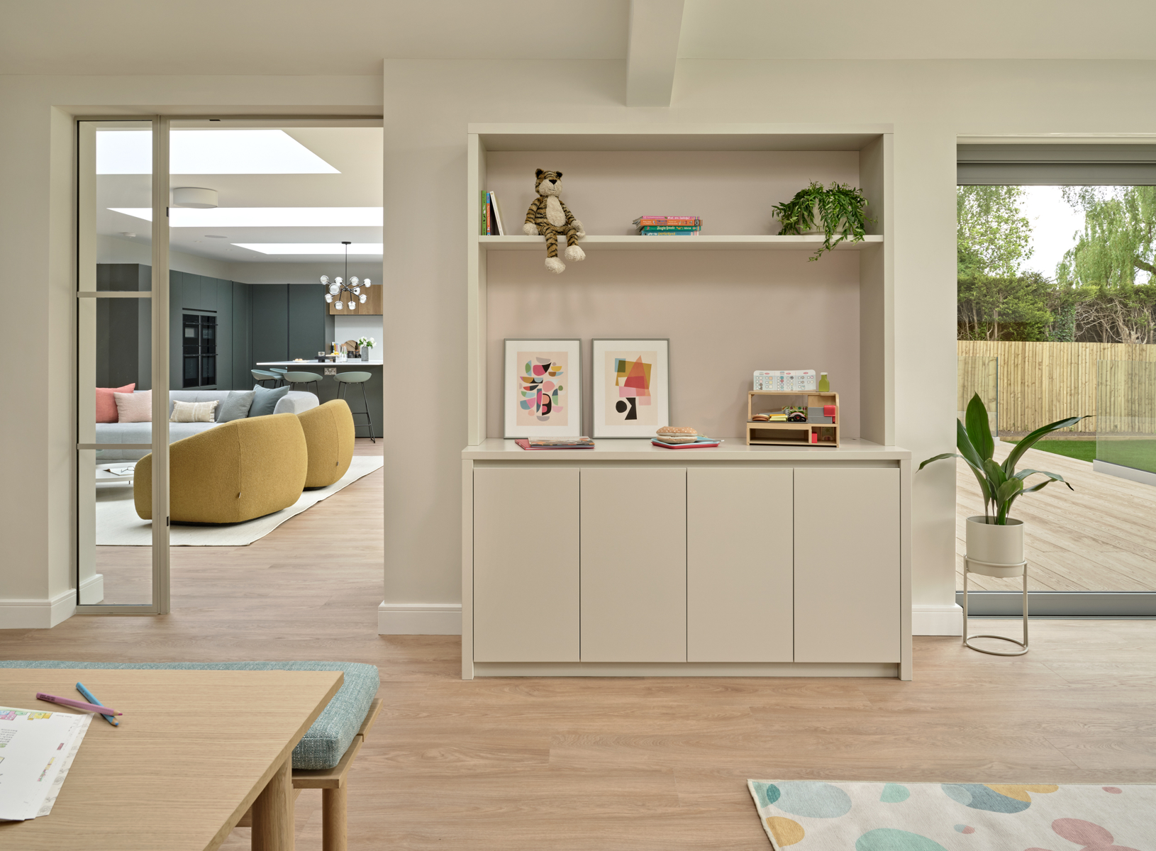 Modern playroom storage unit with view through to open plan space and garden