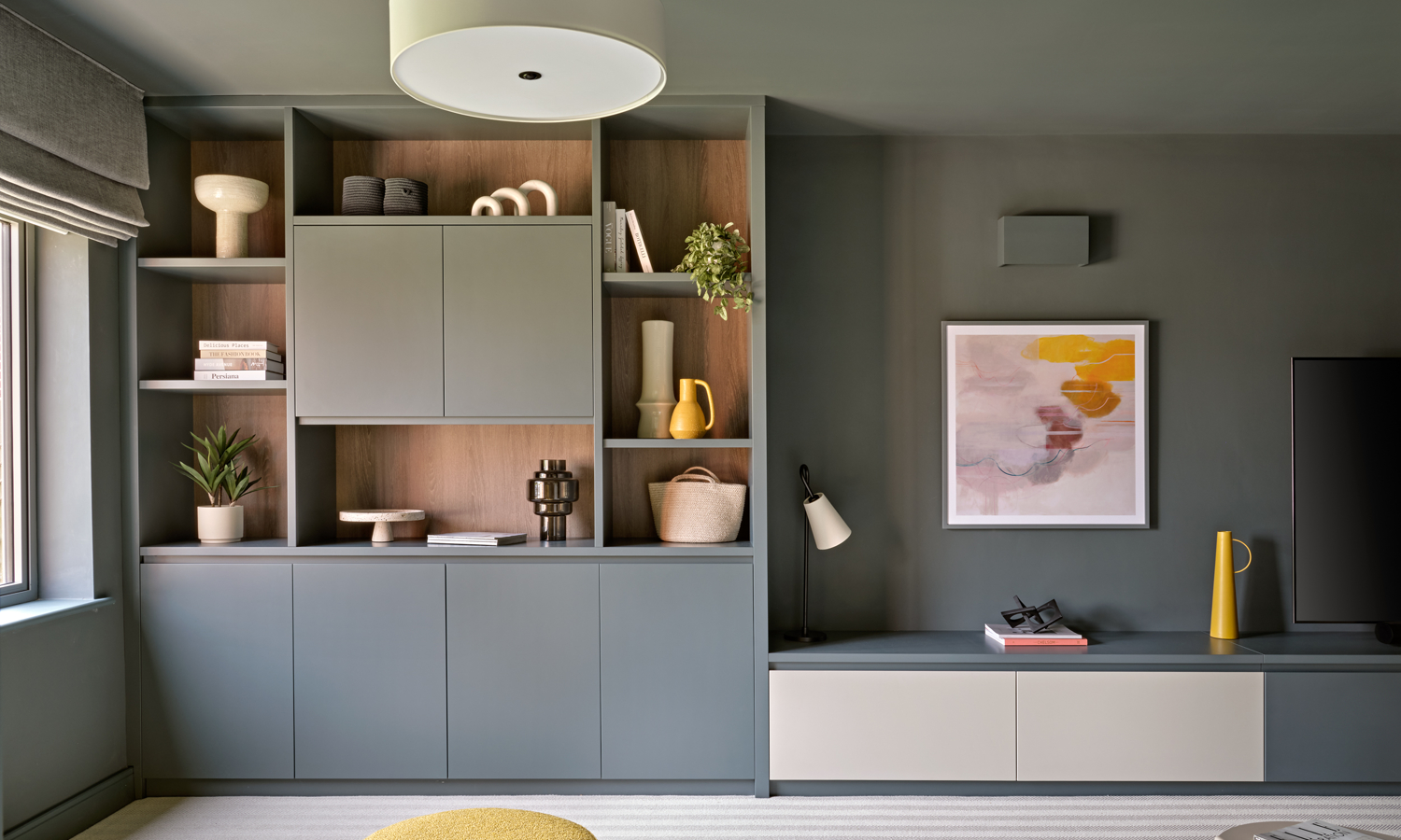 Dark blue grey modern living room with ceilings walls and bespoke fitted wall unit all painted dark blue grey colour