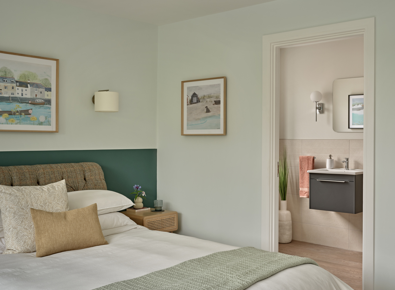 Teal and pale blue bedroom with bed and neutral ensuite