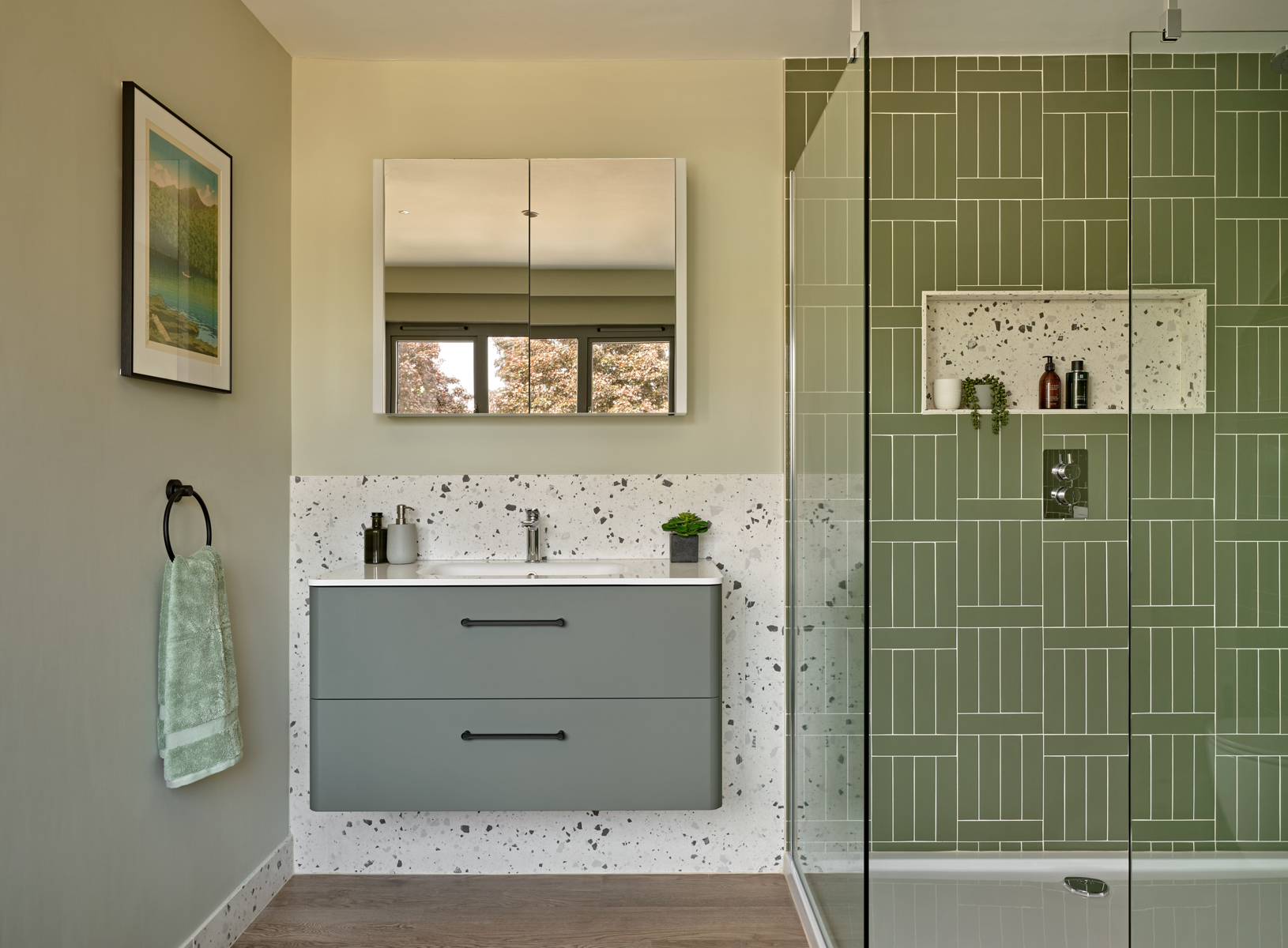 Master ensuite bathroom with green tiles rectangular tiles and terrazzo tiles with dusty green sink unit